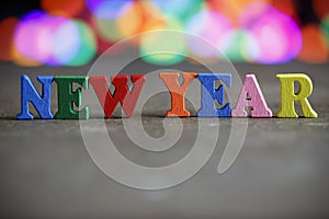 Text Happy New Year of bright multicolored wooden letters