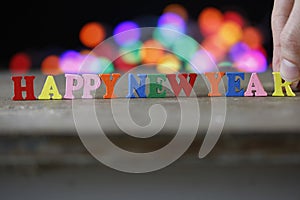 Text Happy New Year of bright multicolored wooden letters