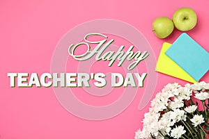 Text Happy Teacher`s Day, beautiful flowers, notebooks and apples on pink background, top view
