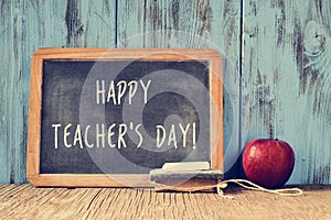 Text happy teachers day written on a chalkboard, retro effect photo