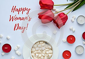 Text Happy Womans day greeting card. Red tulips candles White cup of cacao marshmallows morning breakfast. Holiday