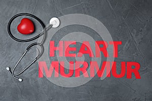 Text Heart Murmur with stethoscope on grey background