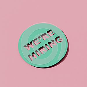 Text we are hiring cut out on paper, square