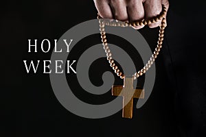Text Holy Week and man with a rosary