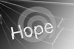 The text Hope on the broken glass. Concept of despair and hopelessness