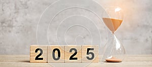 2025 text with hourglass on table. Resolution, time, plan, goal, motivation, reboot, countdown and New Year holiday concepts photo