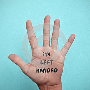 Text I am left-handed in the palm of the hand photo
