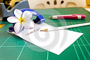 Text I think of you on note pad or memo pad with plumeria or frangipani flower
