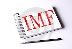 Text IMF on notebook on the white background, business