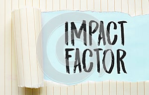 The text impact factor appearing behind torn white paper