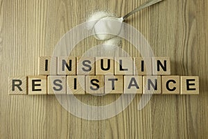 Text insulin resistance from wooden blocks with spoon of sugar