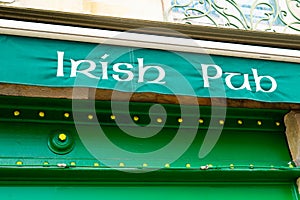 Text irish pub on facade wall front building cafe bar in street