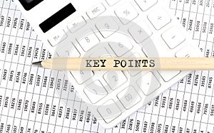 Text KEY POINTS on wooden pencil on calculator with chart