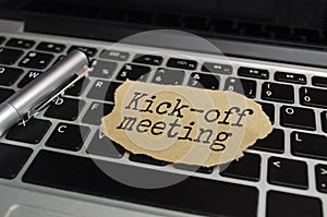 The text KICK-OFF MEETING appearing behind torn brown paper