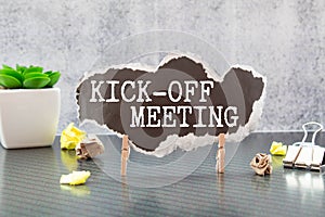 text KICK-OFF MEETING on black torn paper