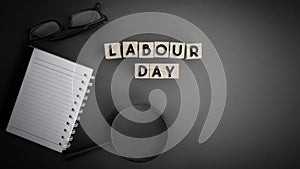 Text LABOUR DAY on wooden blocks concept in vintage background