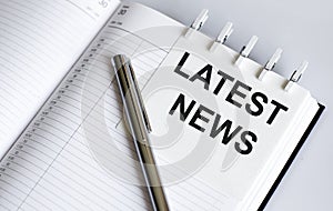 Text LATES NEWS on the short note texture background with pen photo