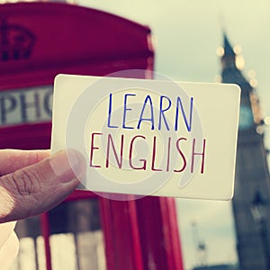 text learn english in a signboard with the Big Ben in the background, with a filter effect