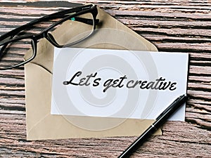 Text lets get creative written on white paper