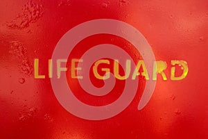 Text Life Guard sprayed a the wall of a life guard stand