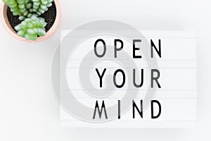 Text on lightbox: Open your mind to new and creative thinking