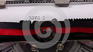 text LOVE IS LOVE written with old typewriter with black ink