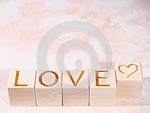 Text LOVE on wood blocks as concept of expressions of sentiment