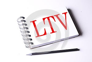 Text LTV on notebook on the white background, business