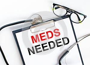 Text Meds Needed in the folder with the stethoscope and glasses