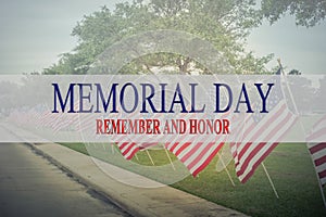 Text Memorial Day and honor on row of lawn American Flags