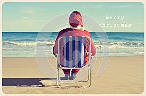 Text merry christmas and santa claus on the beach