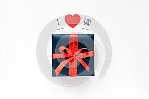 Text message, red paper heart and Blue Gift box wrapped in red ribbon on white background. Top view. Copyspace