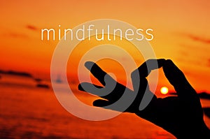Text mindfulness and hand in gyan mudra at sunset