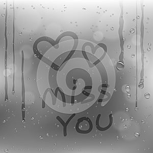 Text miss you and hearts on rainy window