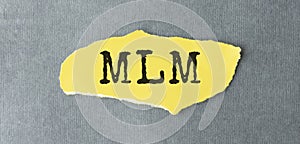 With text MLM Multi Level Marketing on gray background
