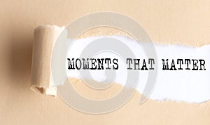 The text MOMENTS THAT MATTER appears on torn paper on white background