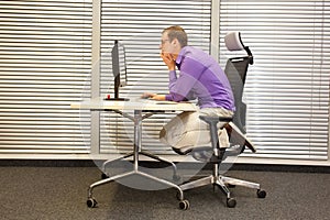 Text neck - man in slouching position working with computer