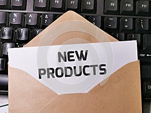 Text NEW PRODUCTS written on white paper note in the envelope