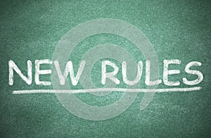 Text NEW RULES written on board