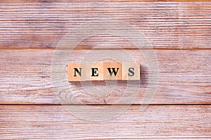 Text news on wood cube. Breaking News Media Announcement Social Concept