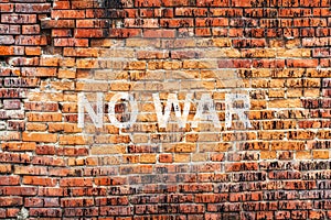 Text NO WAR on stained old orange brick wall texture background