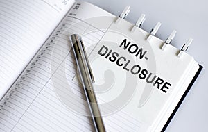 Text Non-Disclosure on the short note texture background with pen. Business concept