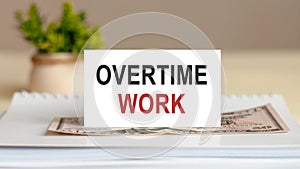Text note - OVERTIME WORK, business concept on notepad