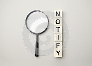 text notify written on a blue background near a magnifying glass and and a calculator. High quality photo