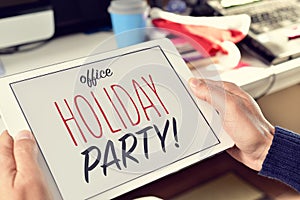 Text office holiday party on a tablet