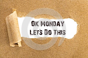 The text Ok Monday Lets Do This appearing behind torn brown paper