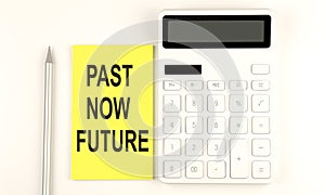 Text PAST NOW FUTURE on yellow sticker, next to pen and calculator