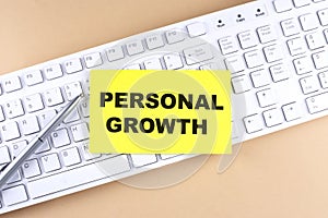 Text PERSONAL GROWTH text on a sticky on keyboard, business concept