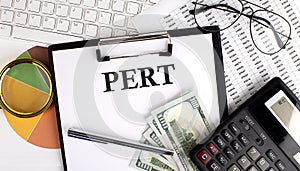 Text PERT on Office desk table with keyboard, dollars,calculator ,supplies,analysis chart on the white background