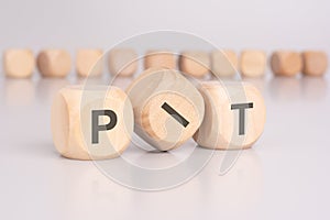text 'PIT' - Personal Income Tax - on wooden cubes